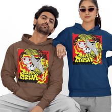 Load image into Gallery viewer, A man and a woman modeling matching graphic hoodies in a studio setting. The man wears a brown hoodie with a colorful cartoon-style chest graphic, paired with light gray sweatpants and white sneakers, sitting on a white block.
