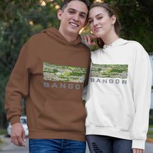 Load image into Gallery viewer, A man and a woman standing together on an outdoor paved walkway, wearing matching hoodies with a landscape graphic and the word 'BANGOR' printed on the chest.